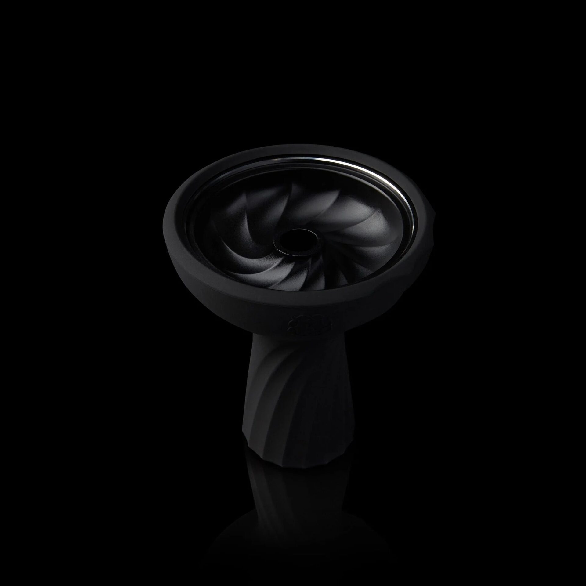 A black hookah bowl with a swirled spiral design, lit dramatically against black.
