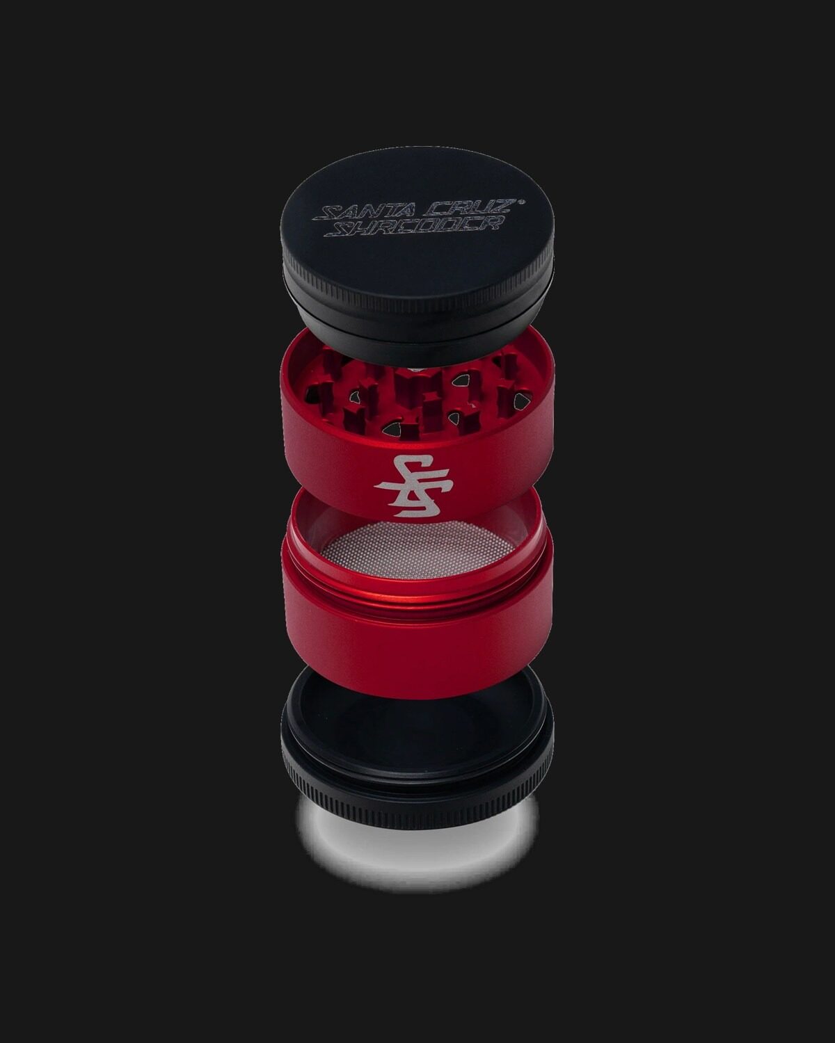 A red and black Santa Cruz Shredder four-piece grinder, disassembled.